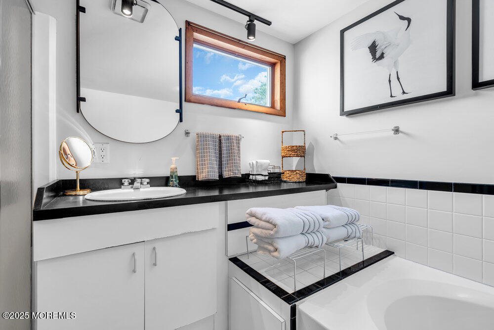 308 16th Avenue Belmar, NJ 07719 - Photo 27 of 54 a bathroom with a sink and a mirror