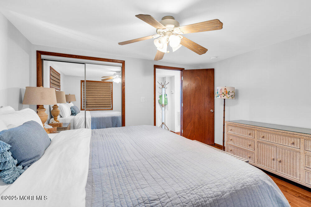 308 16th Avenue Belmar, NJ 07719 - Photo 29 of 54 a bedroom with a large bed and a chandelier