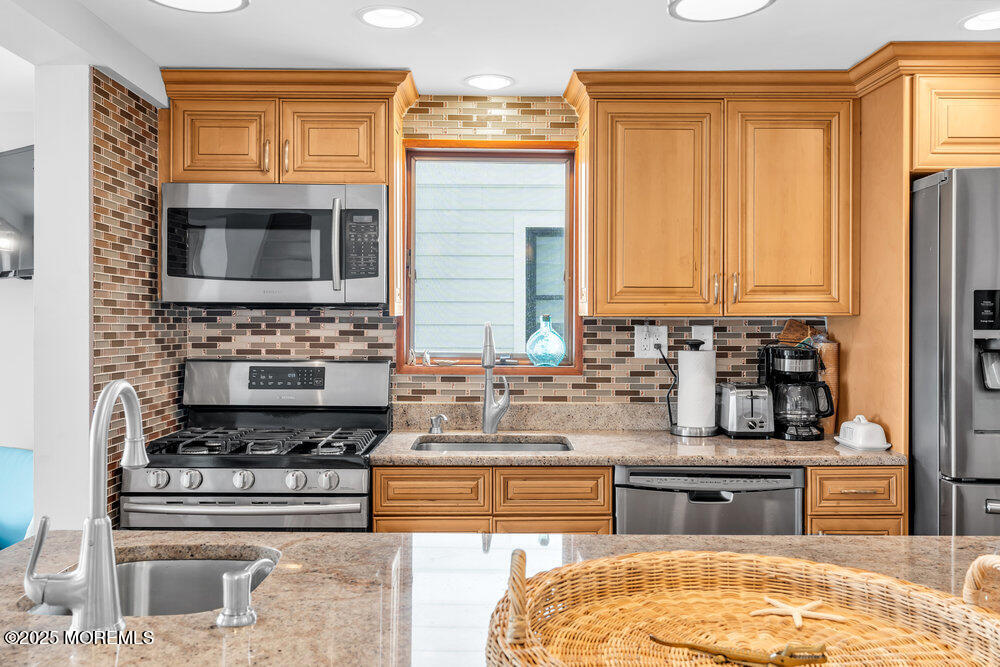 308 16th Avenue Belmar, NJ 07719 - Photo 30 of 54 a kitchen with stainless steel appliances granite countertop a stove and a microwave