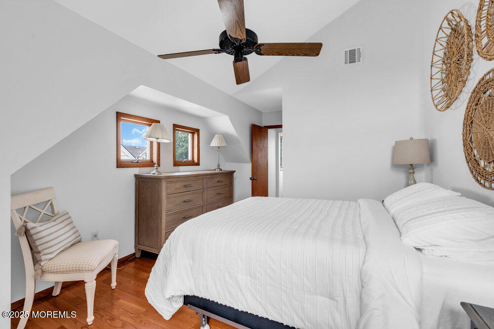 308 16th Avenue Belmar, NJ 07719 - Photo 37 of 54 a bedroom with a bed and a chair