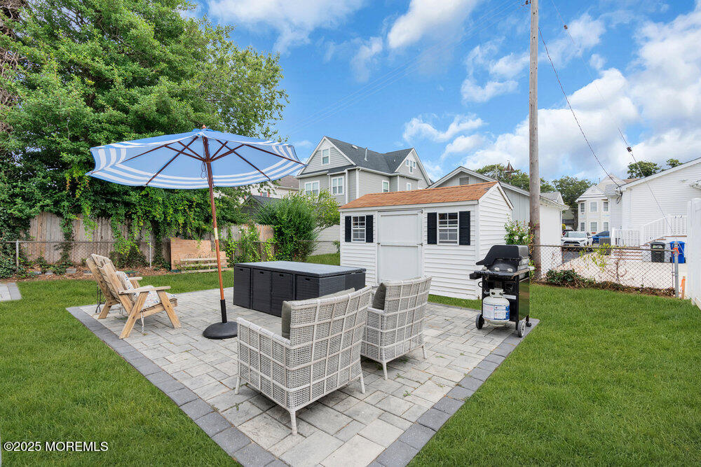 308 16th Avenue Belmar, NJ 07719 - Photo 52 of 54 a view of a patio with table and chairs under an umbrella