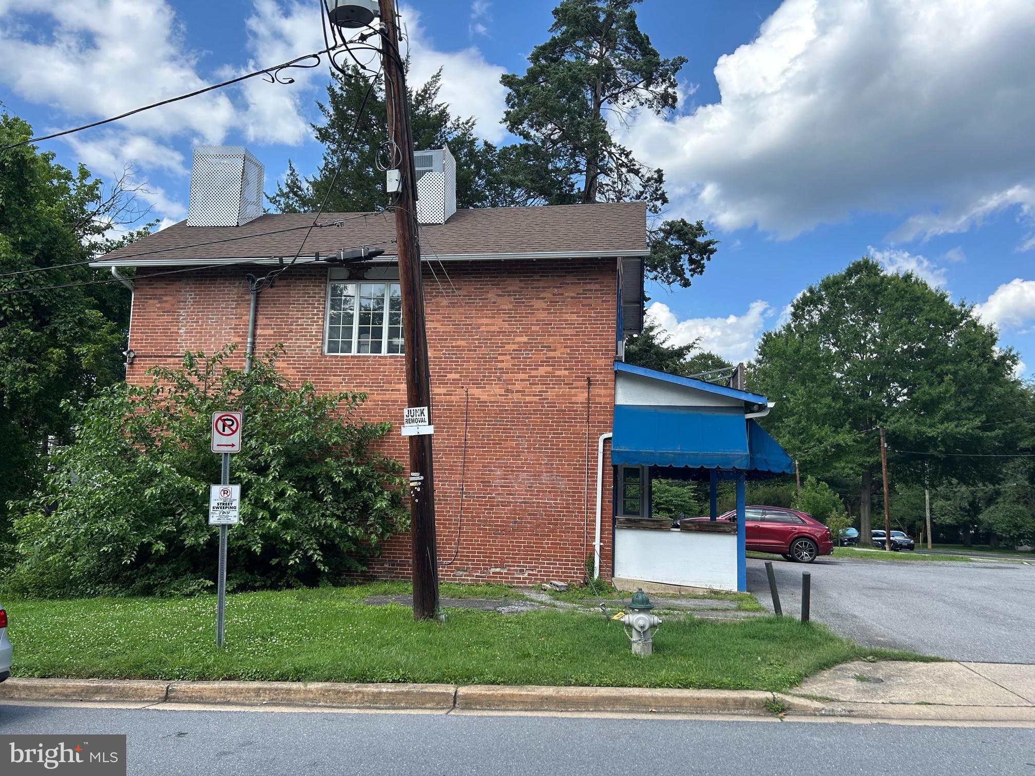 4840-4842 Western Avenue Northwest Bethesda, MD 20816 - Photo 3 of 5 Charming brick building with vibrant awning.