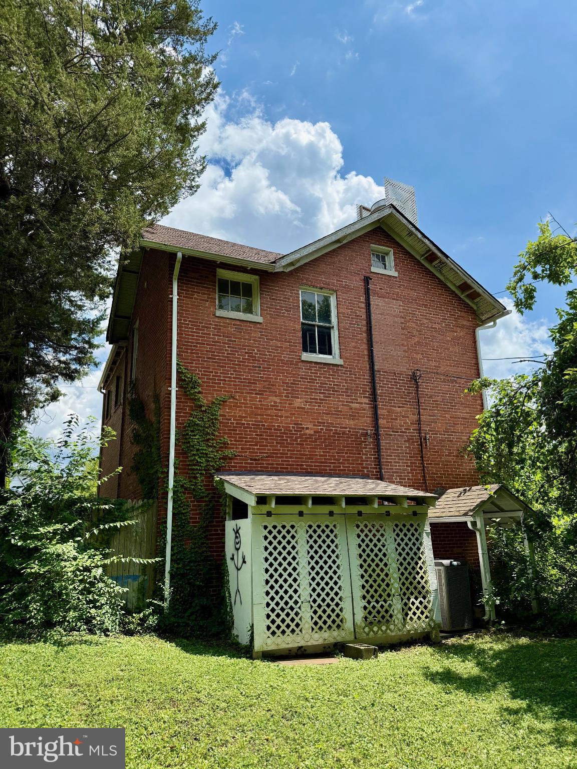 4840-4842 Western Avenue Northwest Bethesda, MD 20816 - Photo 5 of 5 Charming brick home with lush greenery.