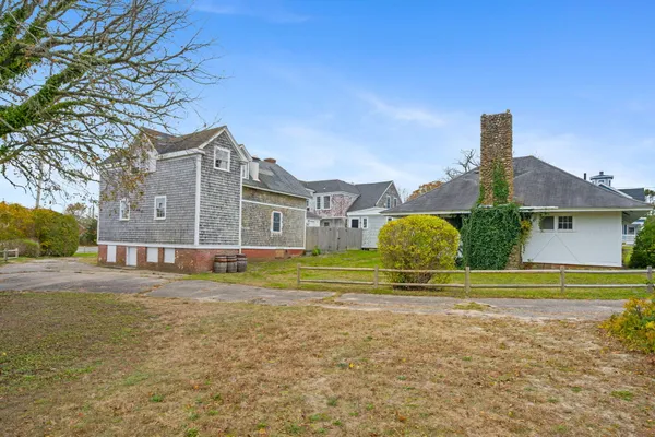 a front view of a house with a garden and plants