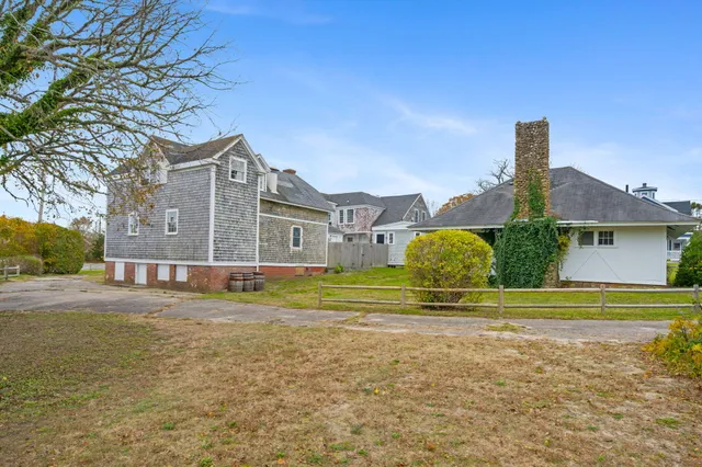 a front view of a house with a garden and plants