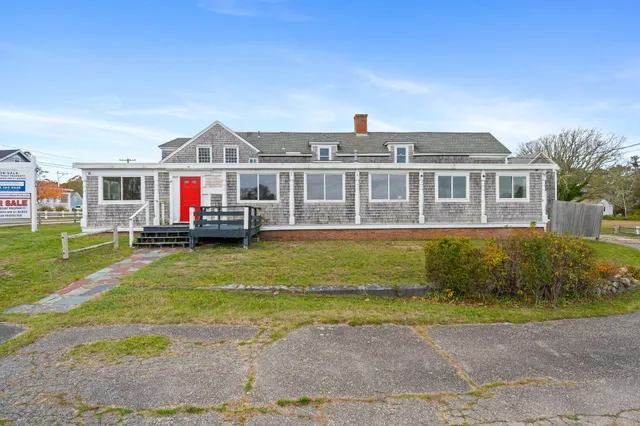 a front view of a house with a yard table and chairs