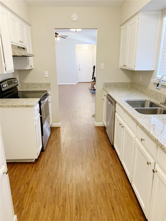5708 Ranchogrande Drive Arlington, TX 76017 - Photo 3 of 21 a kitchen with a sink a stove and cabinets