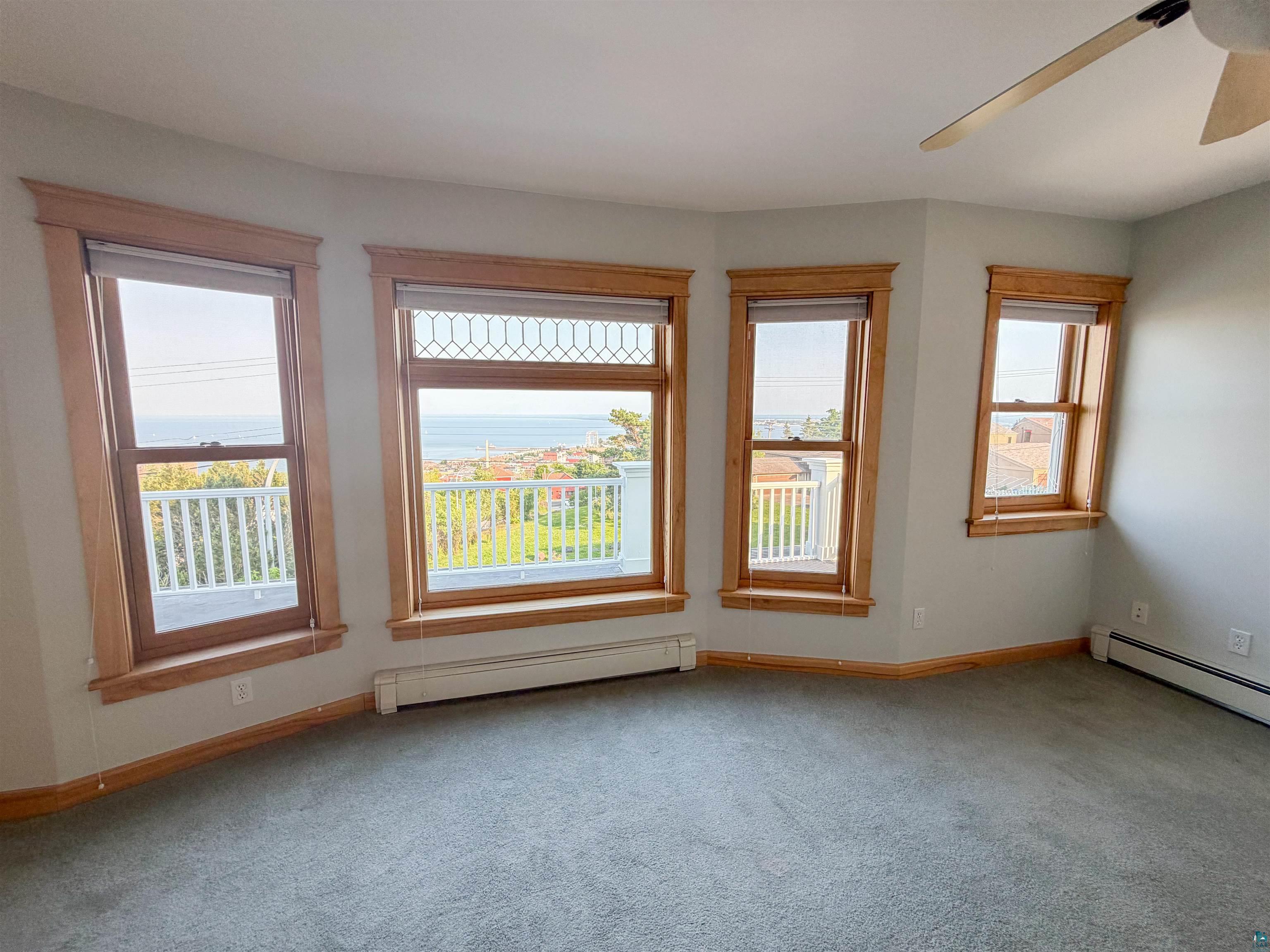 13 West 8th Street Duluth, MN 55806 - Photo 23 of 57 Bay window with natural wood trim, overlooking a body of water and distant land