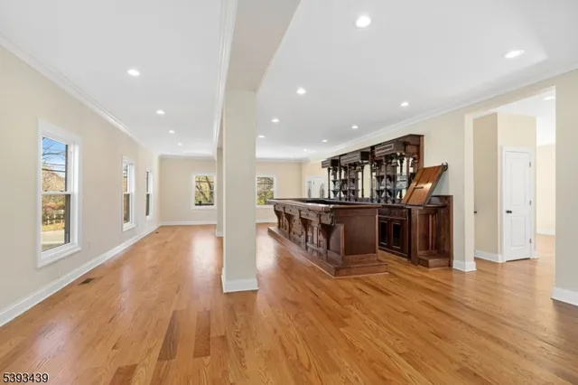 a kitchen with stainless steel appliances kitchen island wooden floors and center island
