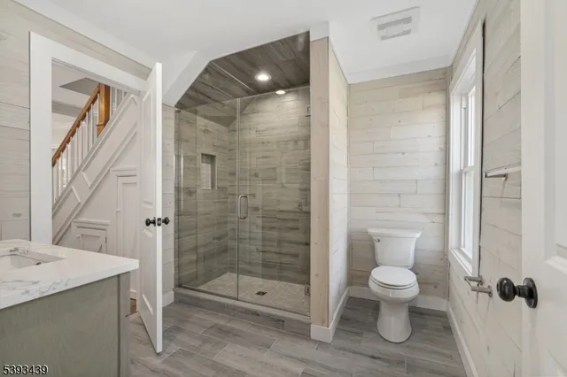 a bathroom with a shower a toilet and a sink