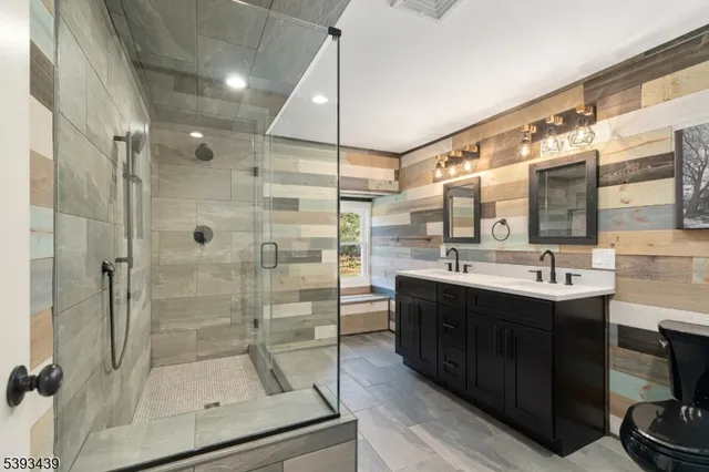 a bathroom with a shower sink and mirror