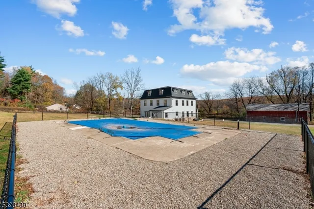 a view of a swimming pool with an outdoor seating