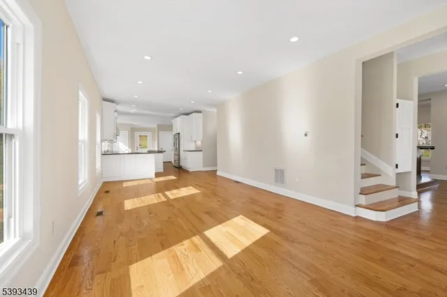 a view of a kitchen with wooden floor and a kitchen
