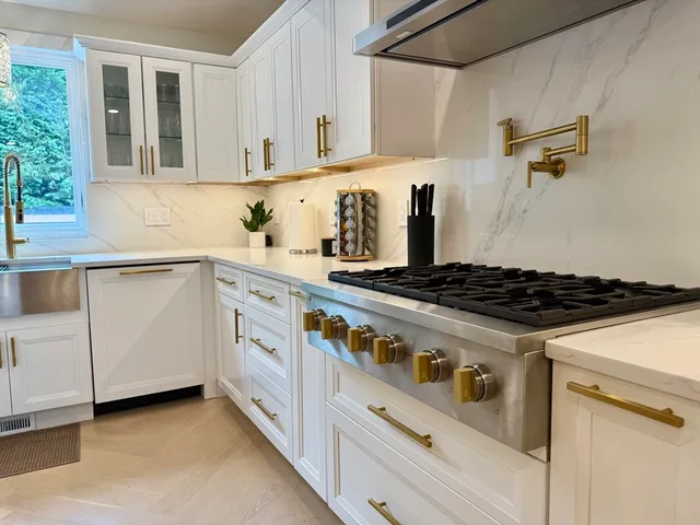 a white stove top oven sitting inside of a kitchen