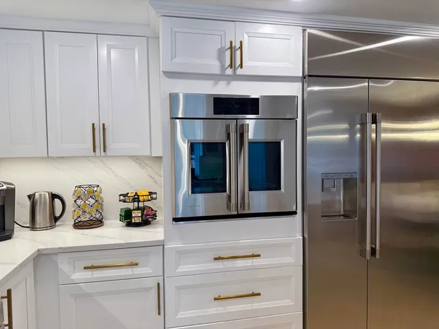 a kitchen with a refrigerator and cabinets
