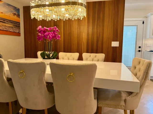 a dining room with furniture and chandelier