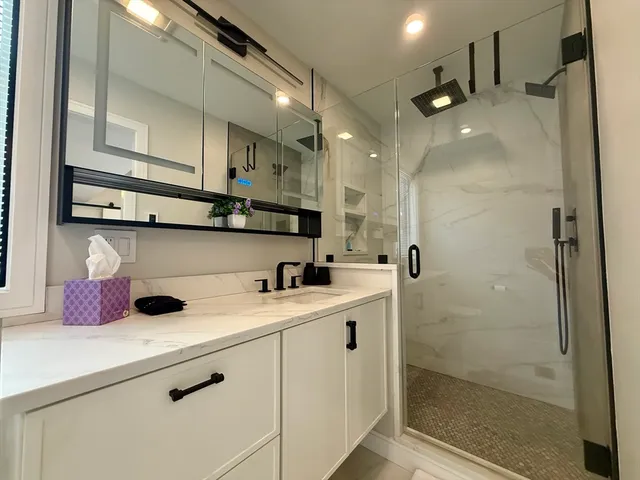 a kitchen with a sink a refrigerator and cabinets