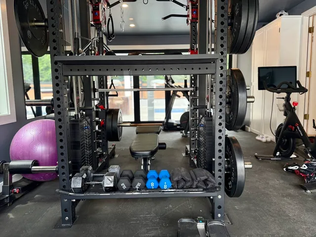 a room with gym equipment and a fireplace