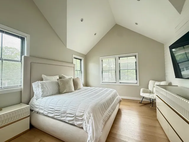 a bedroom with a bed and a flat screen tv