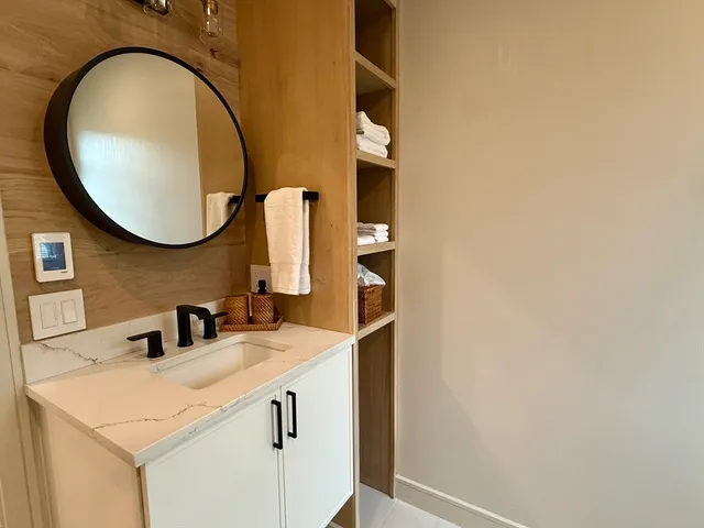 a bathroom with a sink and a mirror
