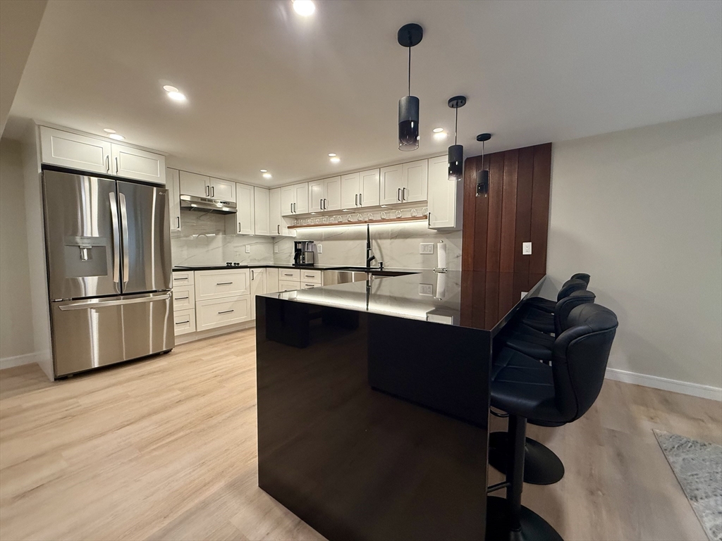 14 Bernard Circle Tisbury, MA 02568 - Photo 33 of 41 a kitchen with stainless steel appliances kitchen island granite countertop a refrigerator a sink dishwasher a stove and a refrigerator