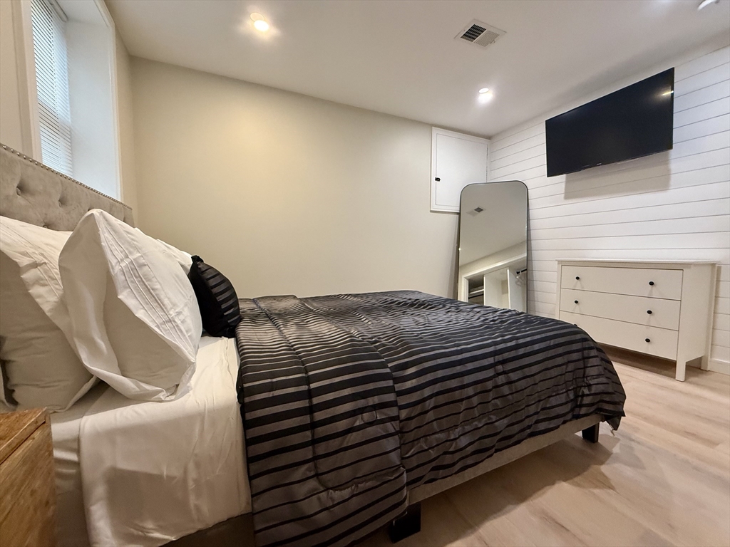 14 Bernard Circle Tisbury, MA 02568 - Photo 37 of 41 a bedroom with a bed and a flat screen tv