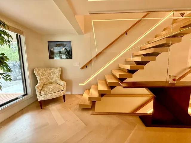 a view of entryway and hall with wooden floor