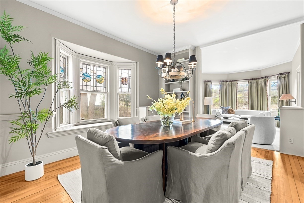 207 Weston Road Wellesley, MA 02482 - Photo 7 of 23 a dining room with furniture a chandelier and wooden floor