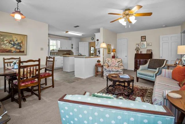 a living room with furniture a rug and a chandelier