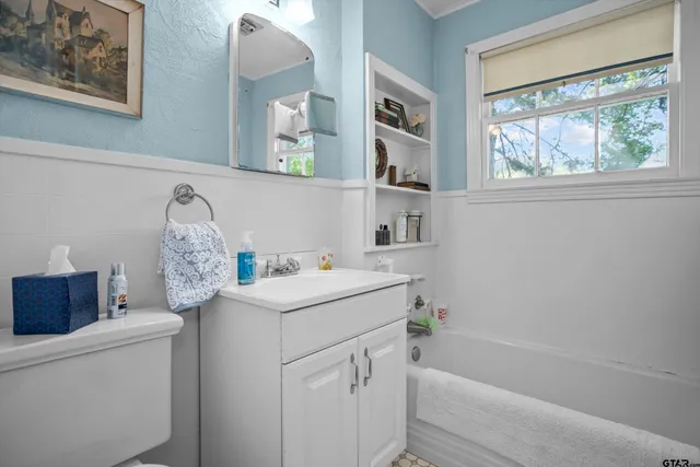 a bathroom with a sink toilet and tub