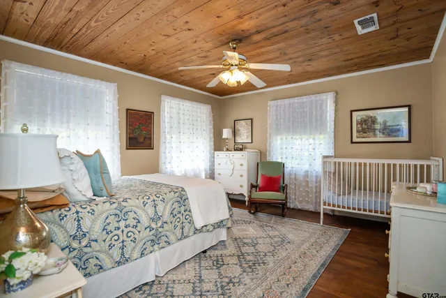 a bedroom with bed and wooden floor