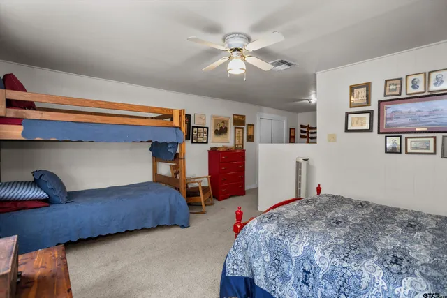 a bedroom with bed and a chandelier