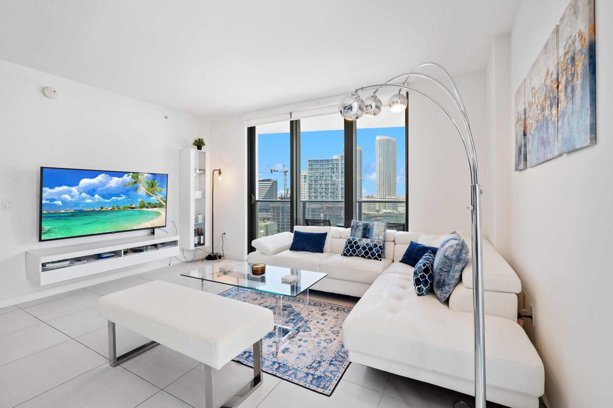 31 Southeast 6th Street, Unit 2002 Miami, FL 33131 - Photo 2 of 24 a living room with furniture and a flat screen tv