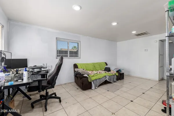 a living room with furniture and a work place area