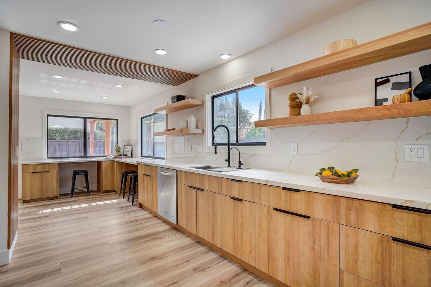 1237 Collins Lane San Jose, CA 95129 - Photo 18 of 56 a large kitchen with stainless steel appliances a large counter top a stove and a sink