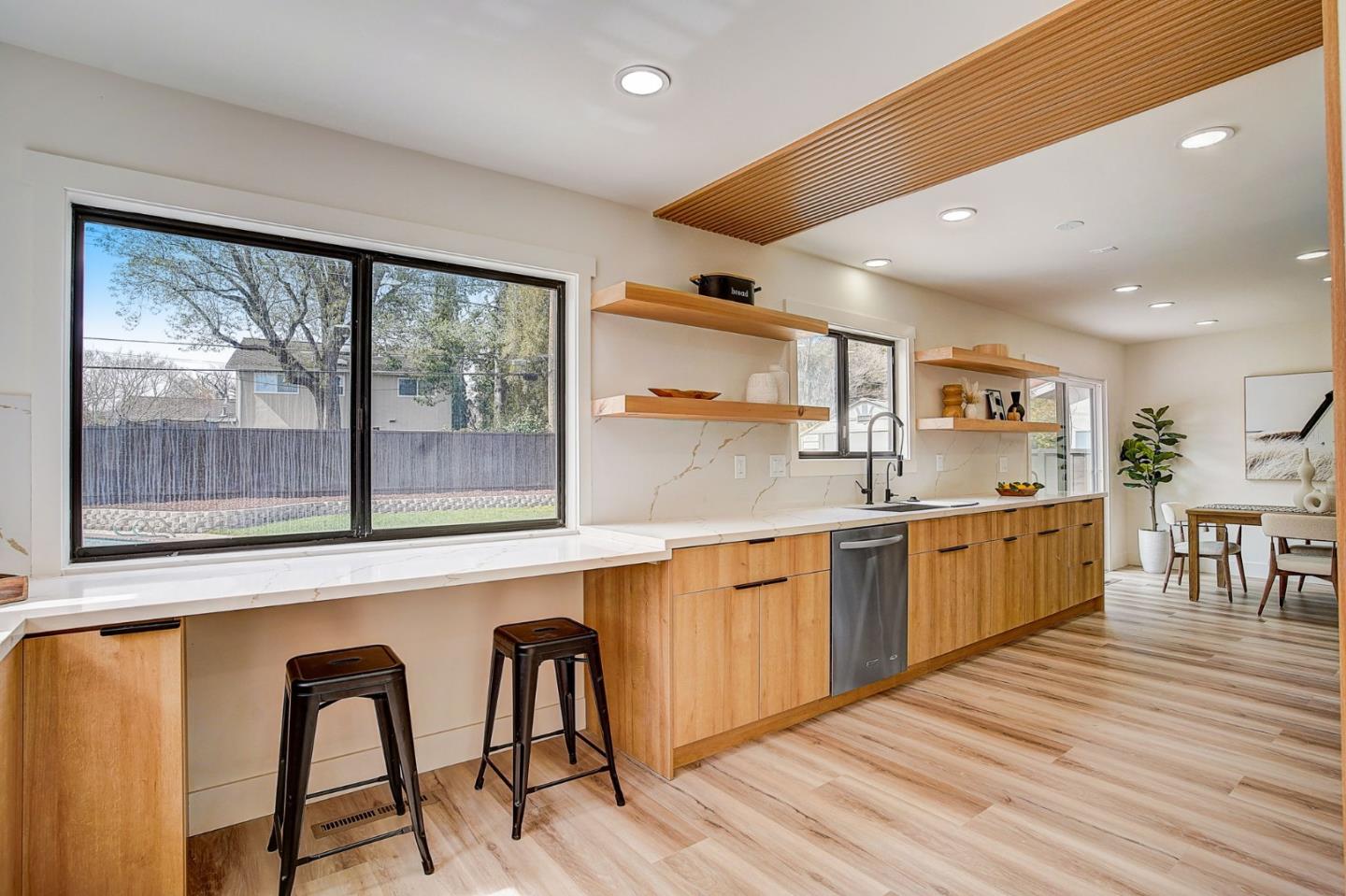 1237 Collins Lane San Jose, CA 95129 - Photo 22 of 56 a kitchen with stainless steel appliances granite countertop a table chairs and wooden floors