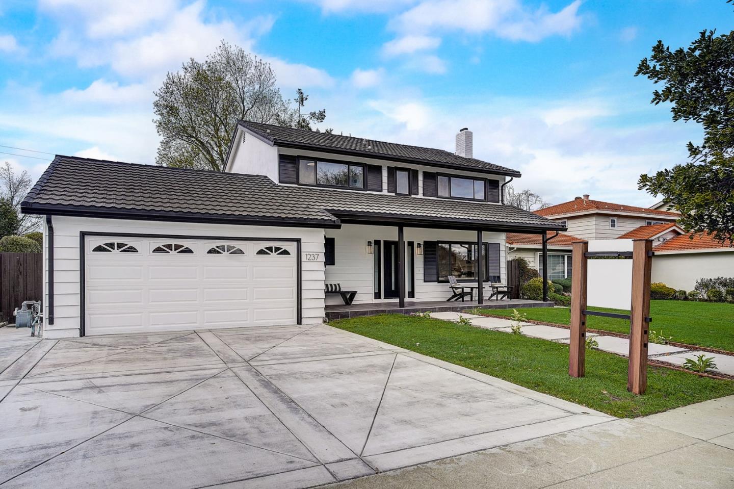 1237 Collins Lane San Jose, CA 95129 - Photo 3 of 56 a front view of a house with a yard table and chairs