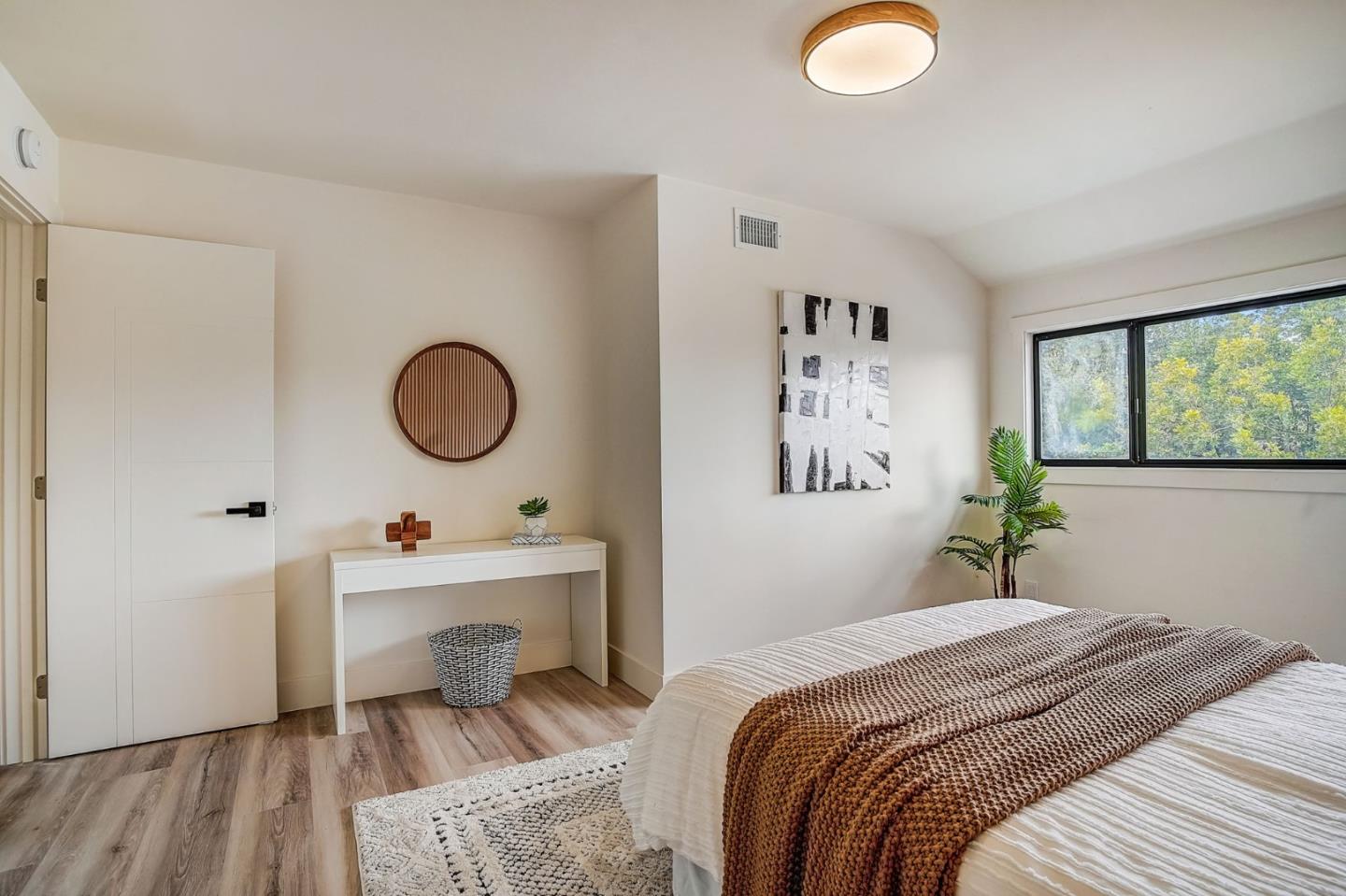 1237 Collins Lane San Jose, CA 95129 - Photo 35 of 56 a bedroom with a bed and a chandelier