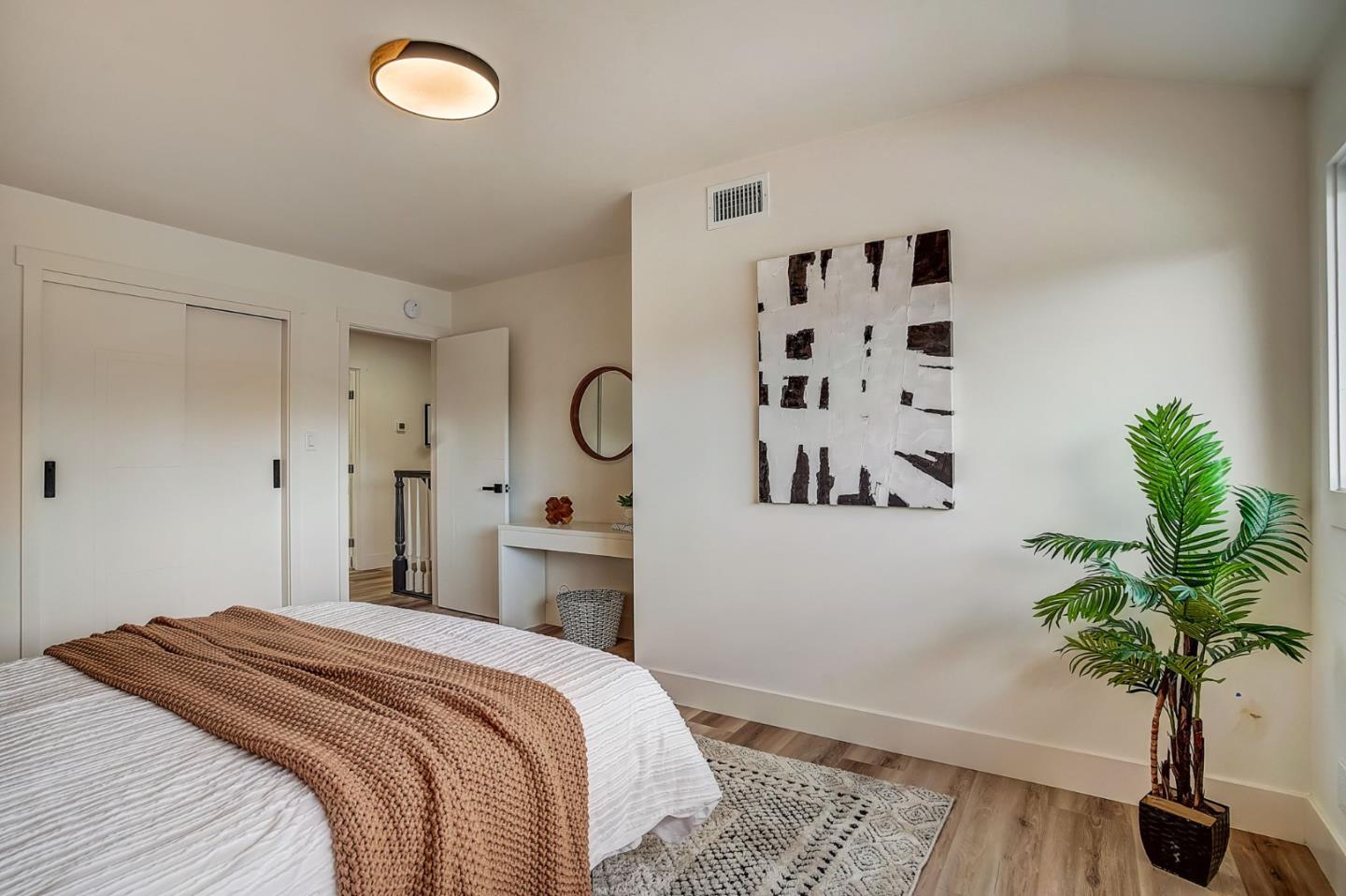 1237 Collins Lane San Jose, CA 95129 - Photo 36 of 56 a bedroom with a large bed and a potted plant