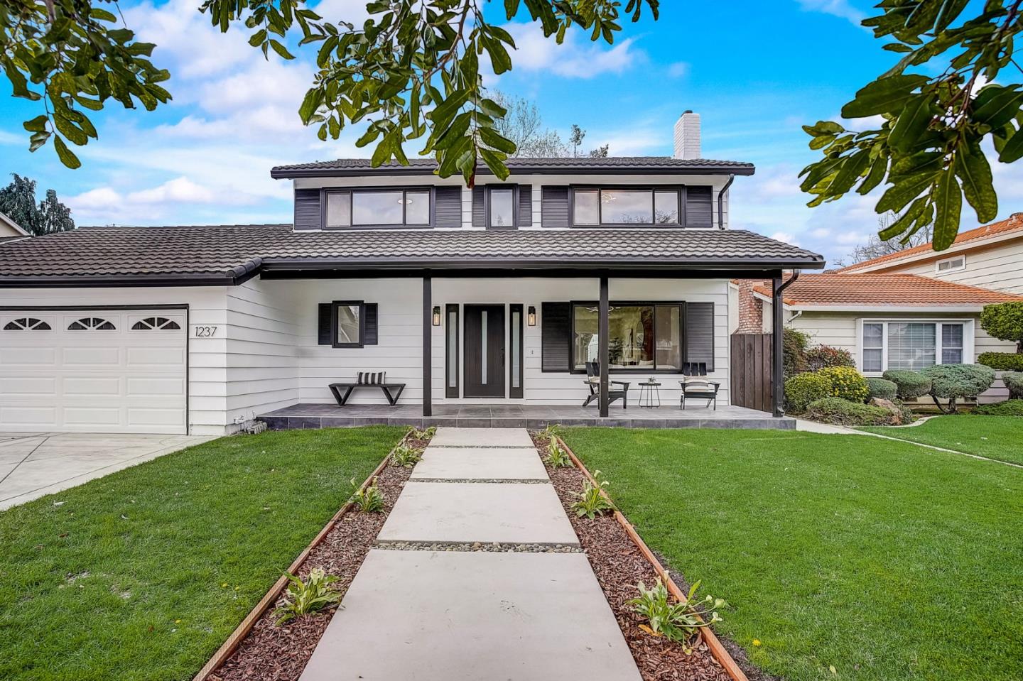 1237 Collins Lane San Jose, CA 95129 - Photo 4 of 56 a front view of a house with a garden