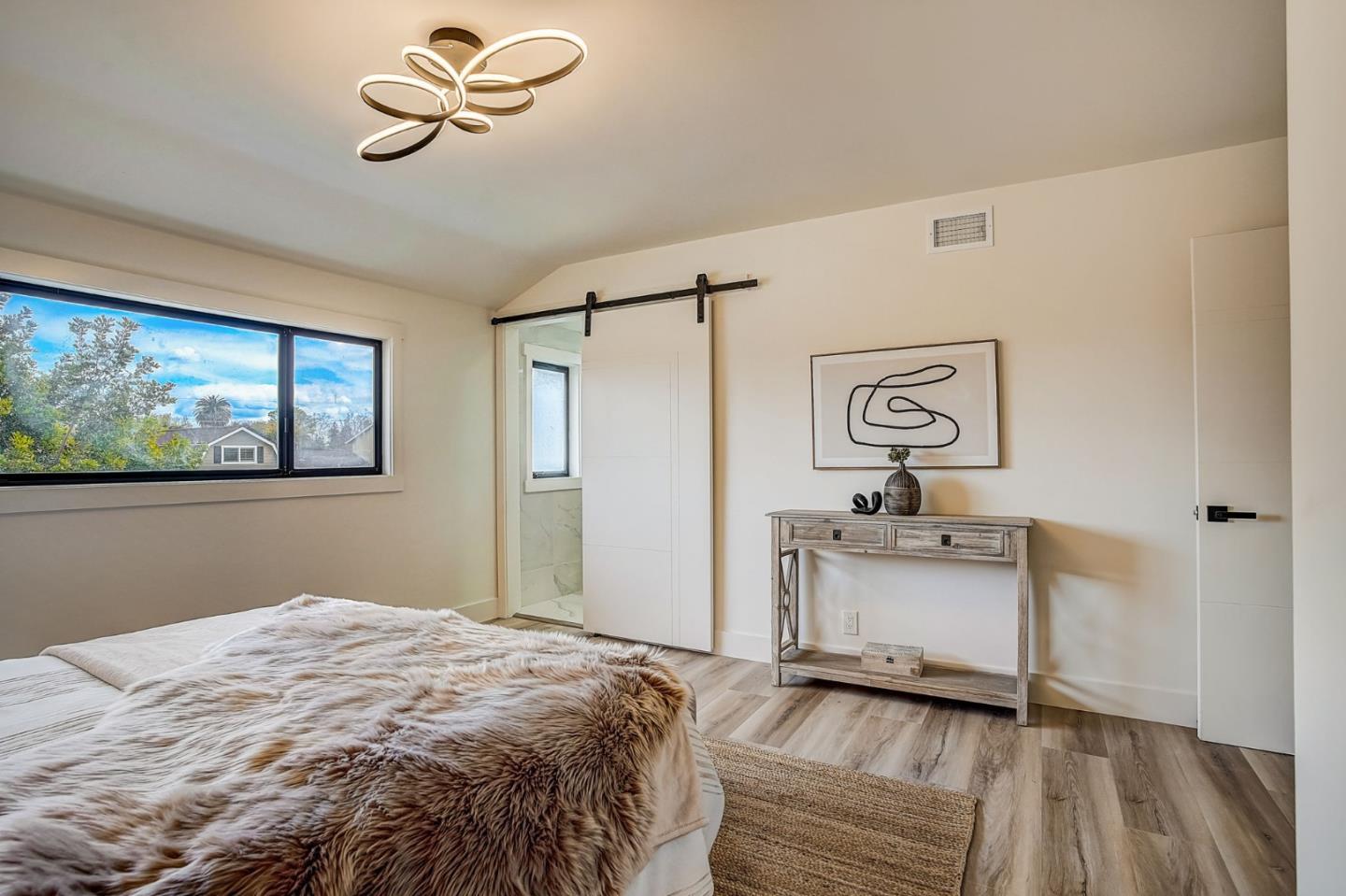 1237 Collins Lane San Jose, CA 95129 - Photo 41 of 56 a bedroom with a bed and a chandelier