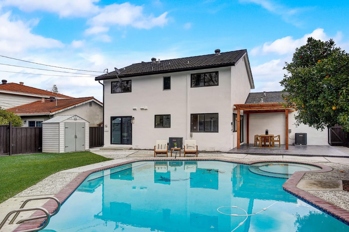 1237 Collins Lane San Jose, CA 95129 - Photo 51 of 56 a white house with a large pool yard and couches chairs