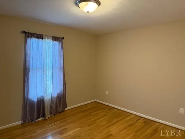 a view of an empty room and wooden floor