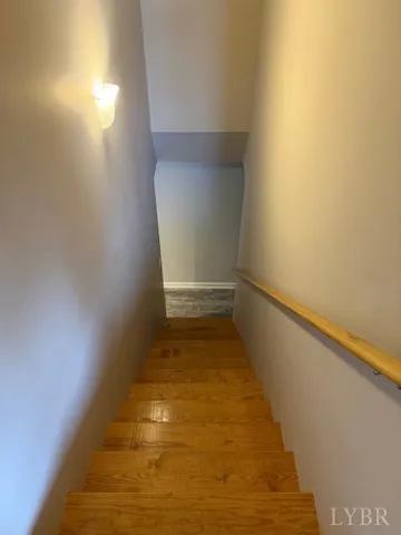 a view of a room with wooden floor and white walls