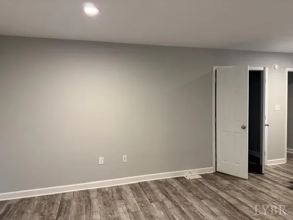 an empty room with wooden floor and closet