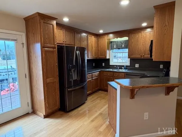a kitchen with stainless steel appliances granite countertop a refrigerator and a sink