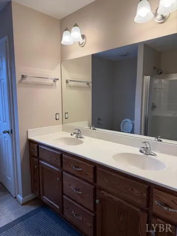 a bathroom with a sink double vanity and a mirror
