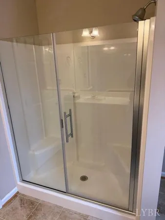 a bathroom with a glass door shower