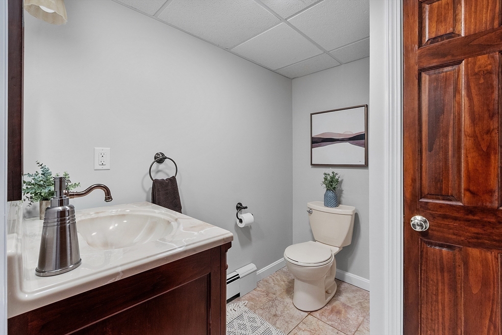 1155 Liberty Square Road Boxborough, MA 01719 - Photo 34 of 42 a bathroom with a toilet a sink and mirror
