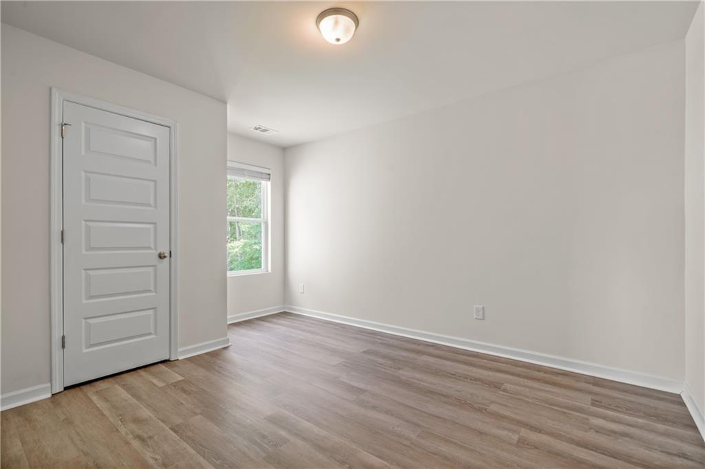 631 Carlton Pointe Drive, Unit 24 Palmetto, GA 30268 - Photo 12 of 20 wooden floor in an empty room